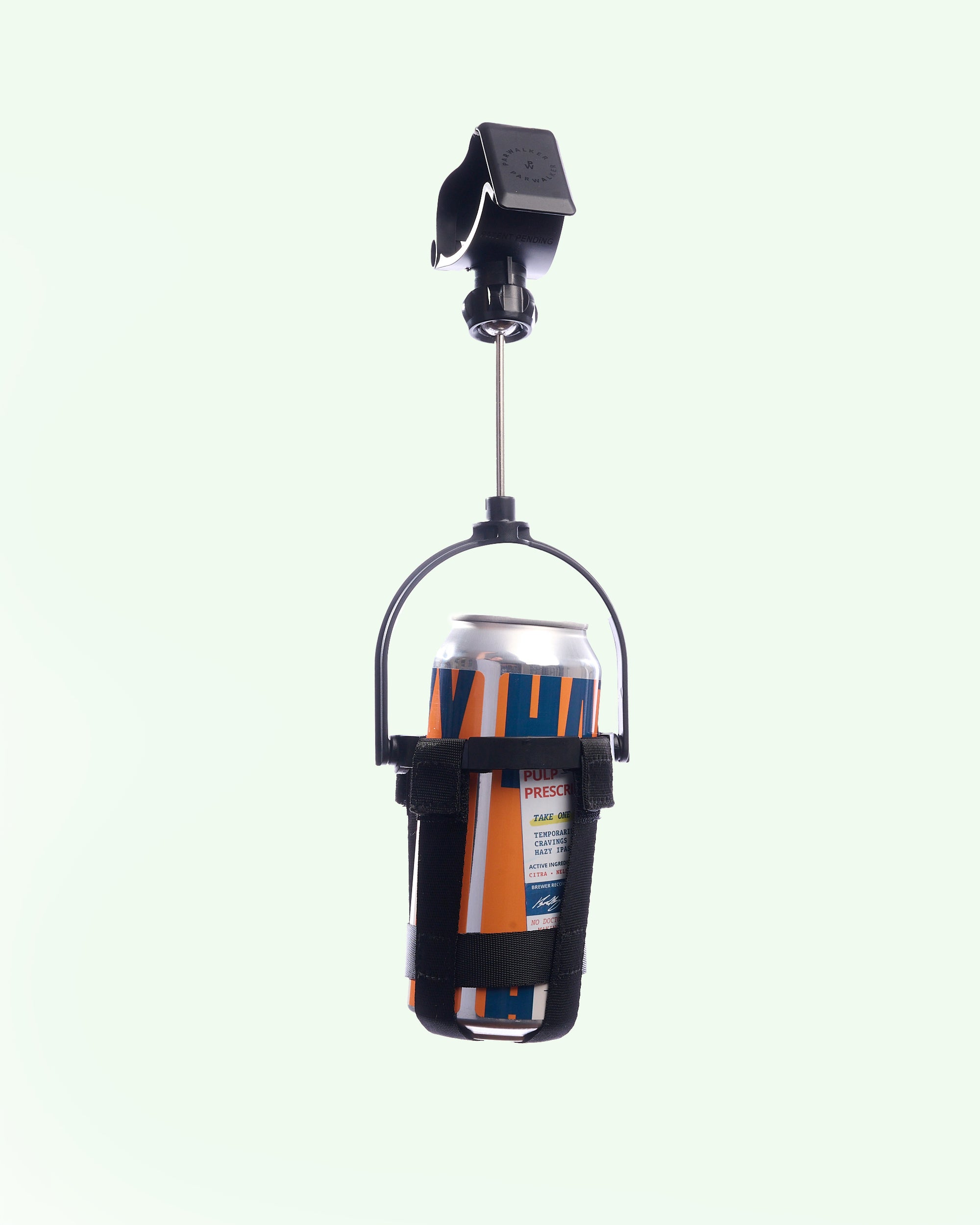 The black Dangler holder suspending a can, on a pale mint studio background.