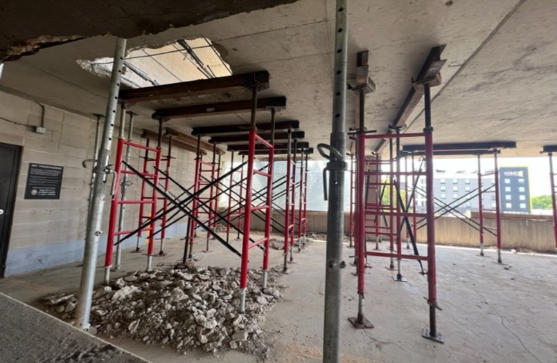 Structural repair work in progress at the University of Minnesota Prospect Park parking ramp showing concrete and post-tension cable restoration