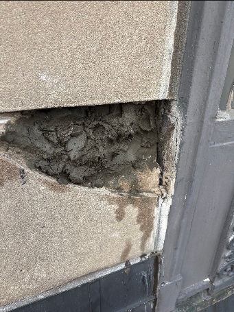 Deteriorated stone on the Wisconsin Tower Condominiums showing significant damage requiring repair before restoration work