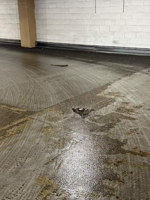 Spalled and damaged concrete on a Minneapolis hospital parking ramp surface showing deterioration prior to demolition and replacement