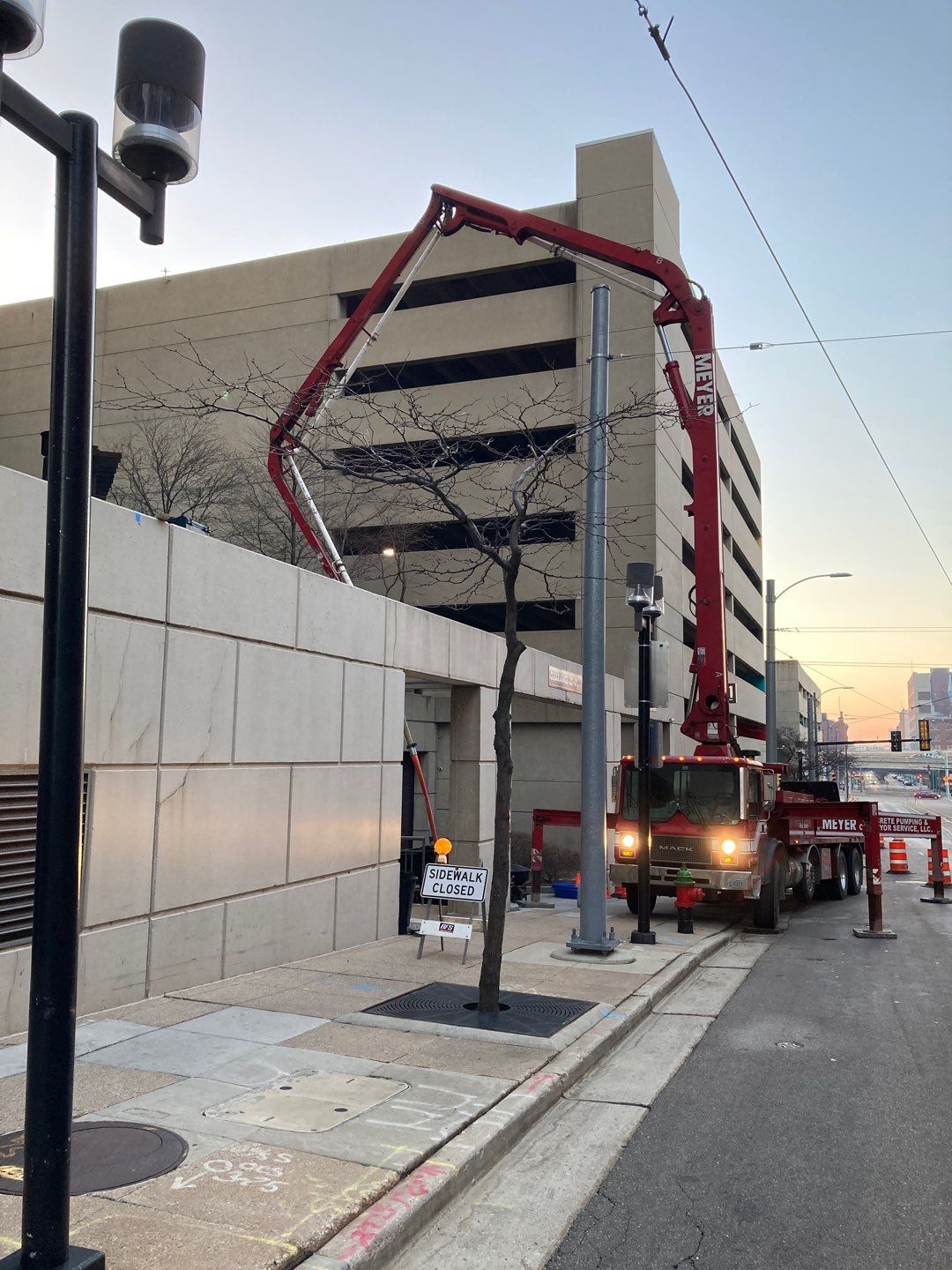 Hot-applied waterproofing membrane installation on an elevated plaza deck in downtown Milwaukee, adjacent to the city's light rail system