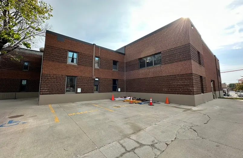 Human Services Building limestone panel restoration showing precision facade repair