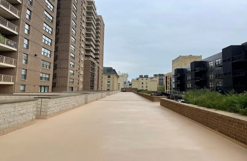 Completed walk path and pavement showing finished restoration work at RiverWest parking structure