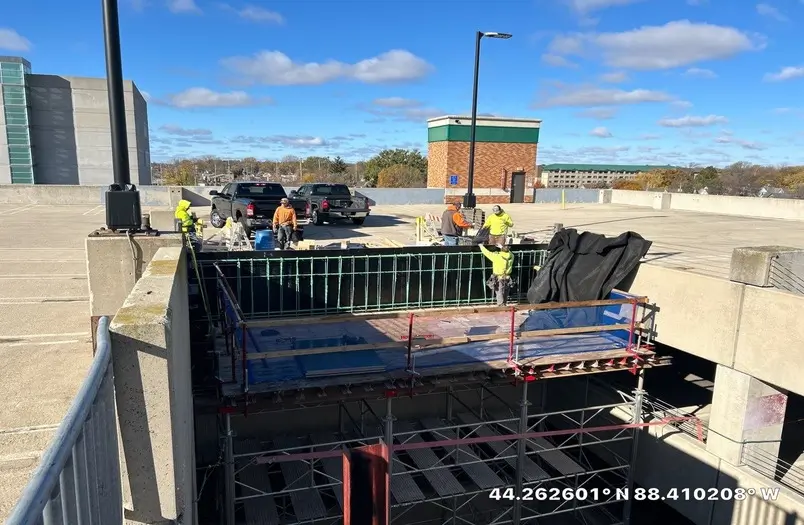 RSI crew installing temporary shoring and formwork on the fifth story of the Appleton parking ramp during cast-in-place barrier wall replacement