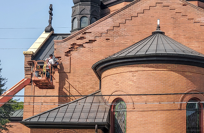 St. Mary's Church stone restoration project in Minneapolis showing detailed ornamental masonry work on historic facade