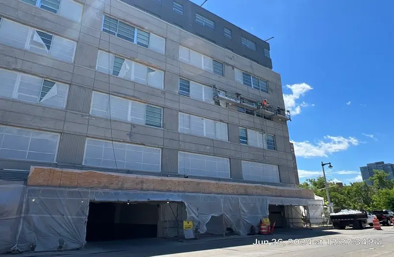 Kenilworth Square Apartments in Milwaukee during concrete facade restoration by RSI, showing coating removal and repair work