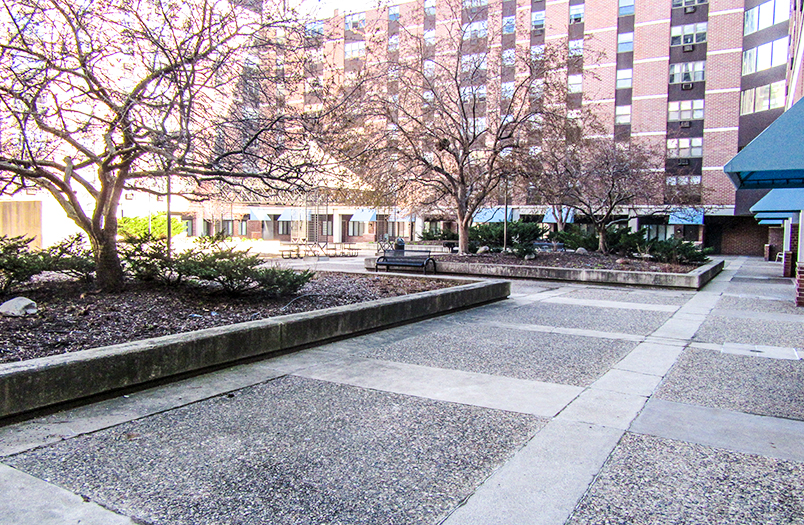 Mears Park Place plaza deck before restoration showing deteriorated waterproofing and surface damage
