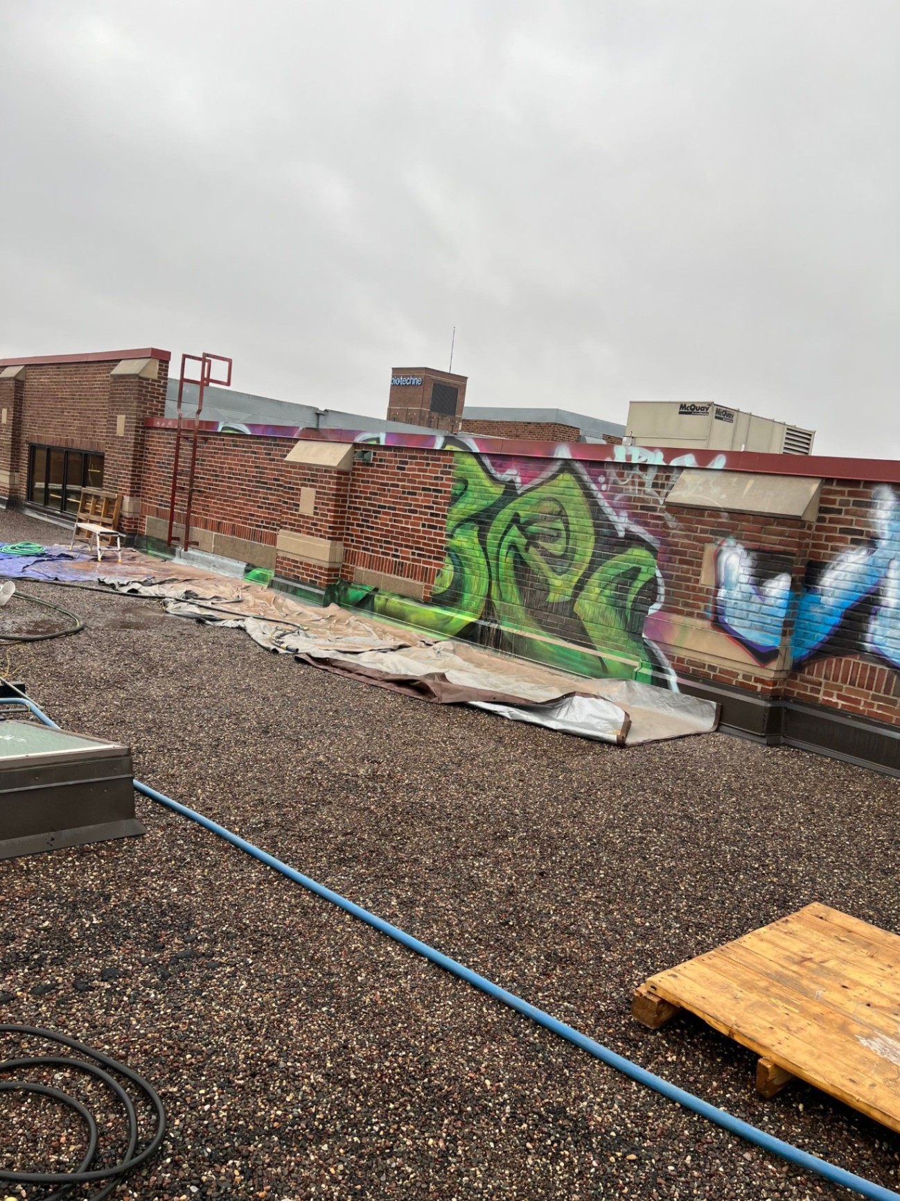 Graffiti mid-removal process on the Bio-Techne headquarters exterior