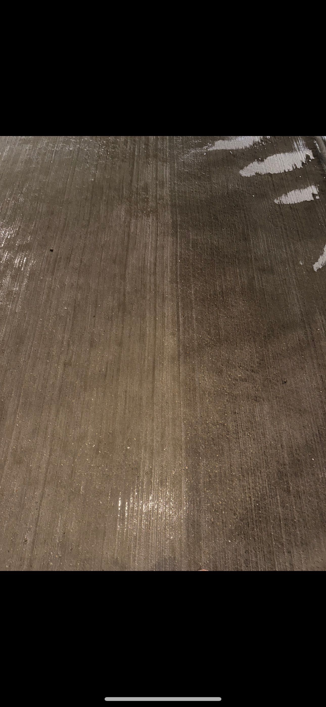 Concrete parking deck surface showing before-and-after contrast after RSI high-pressure surface cleaning in Madison, WI