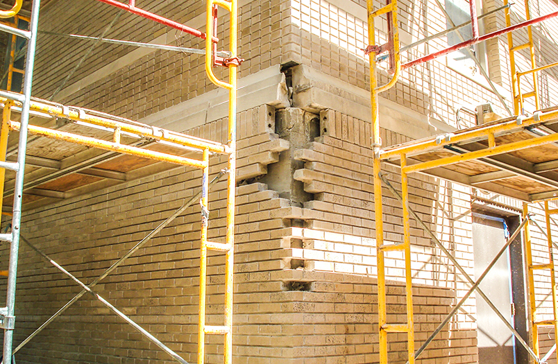 Lourdes Hall at Winona State University, a historic institutional building requiring mortar-compatible tuckpointing across 56,000 square feet of facade with Indiana Limestone replacement