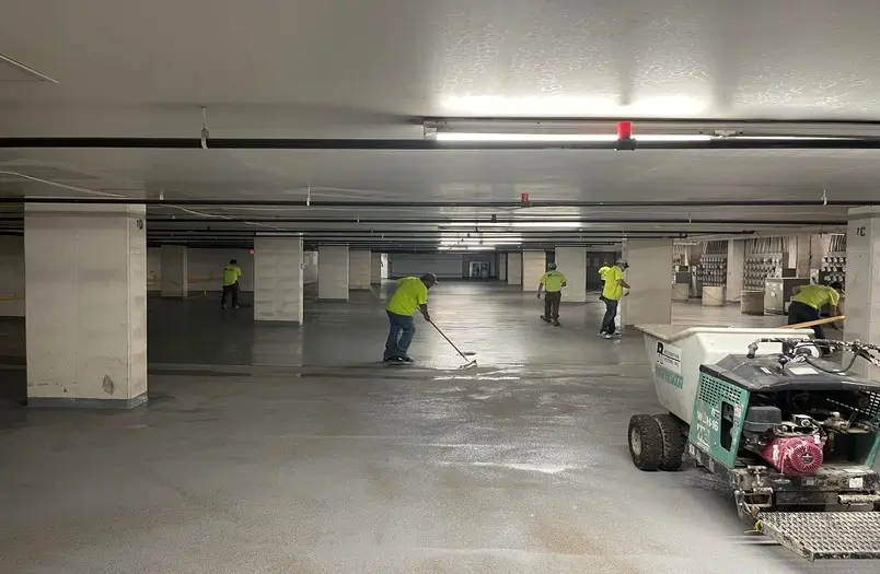 RiverWest parking garage in Minneapolis showing new high-solids polyurethane traffic coating and penetrating sealer application on a condominium parking structure