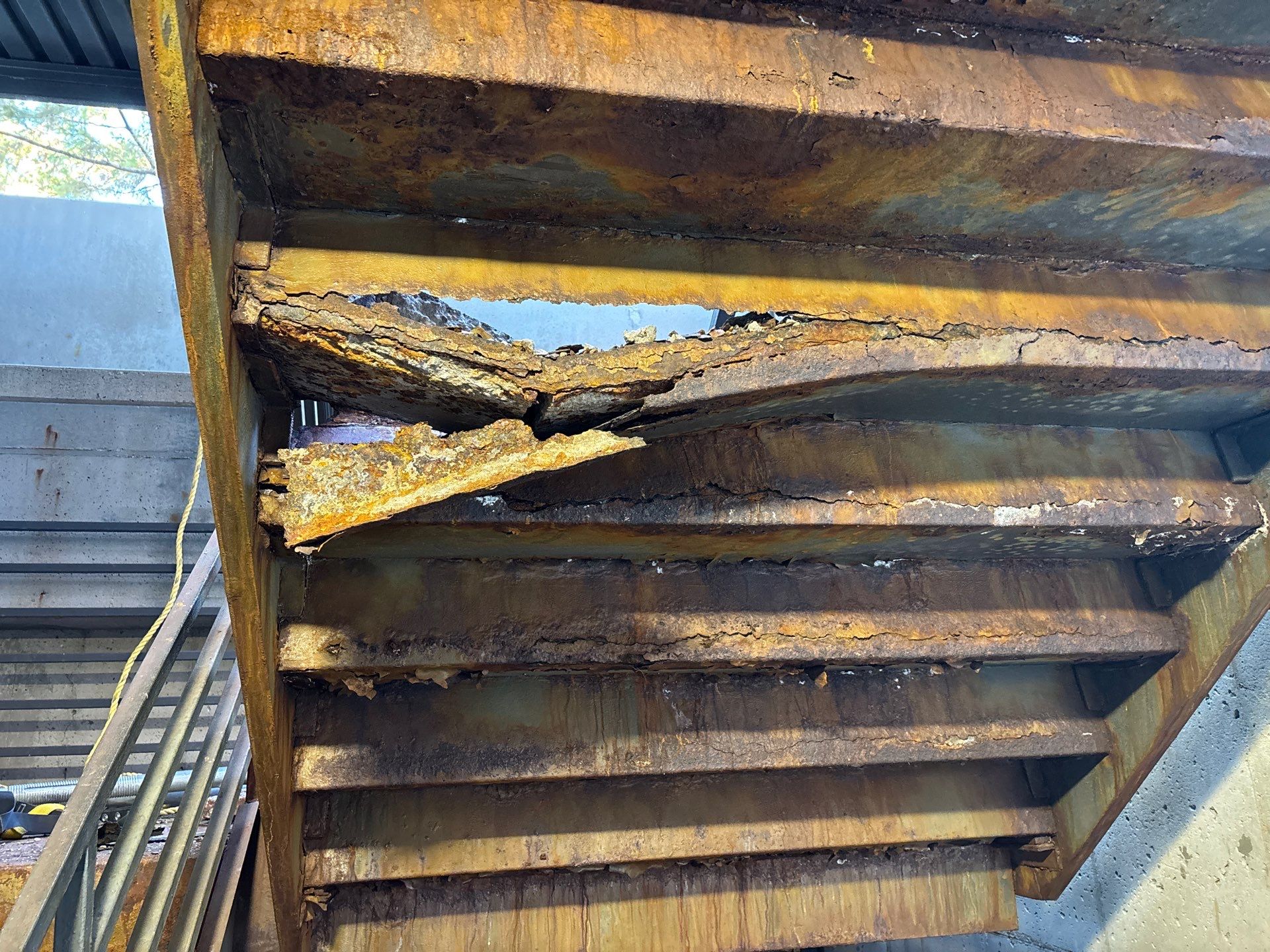 Deteriorated metal staircase with structural rust failure prior to RSI replacement in Bloomington, MN