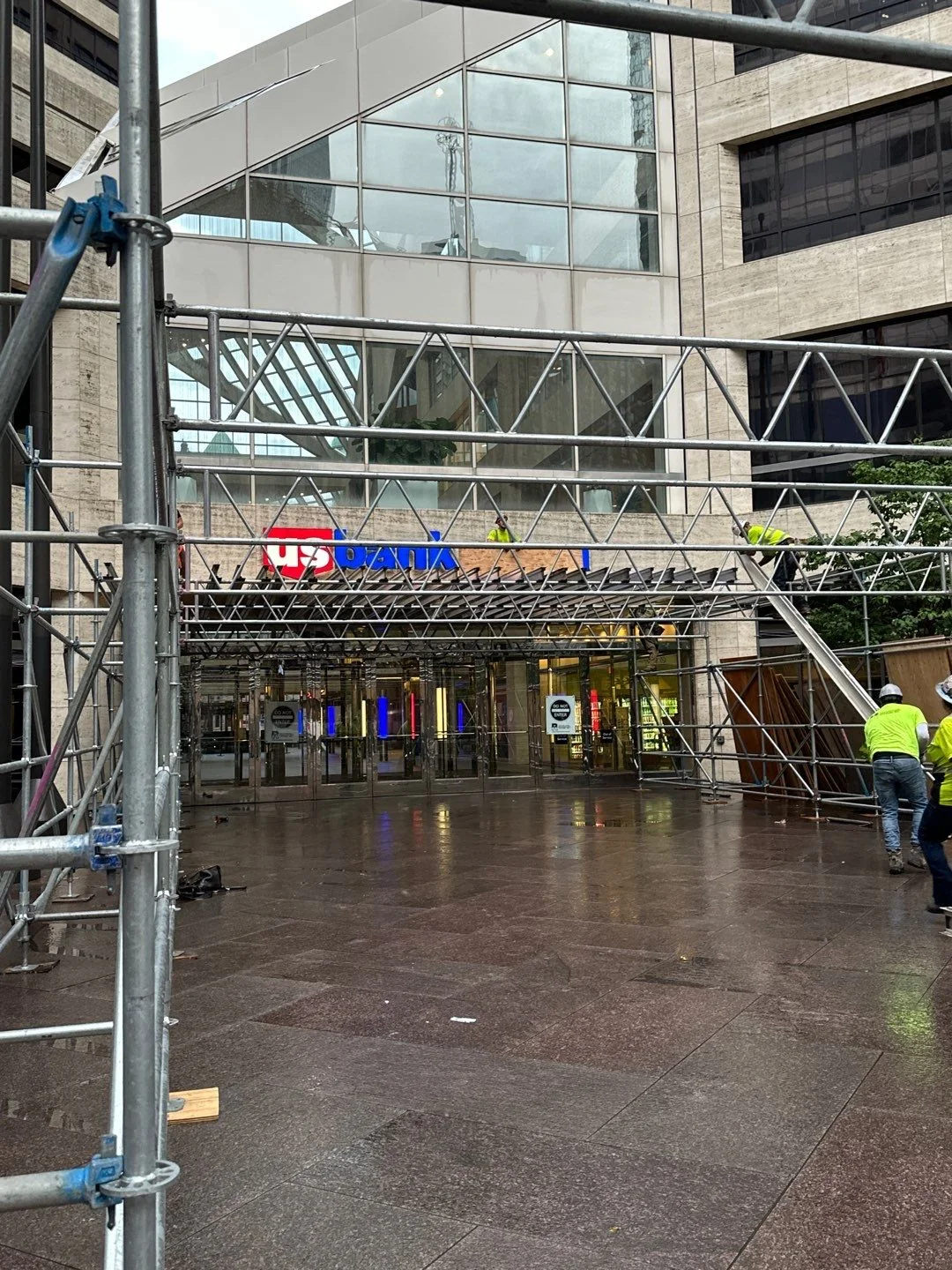 Pedestrian protection scaffold tunnel installed at the U.S. Bank Plaza entrance in downtown Minneapolis, with RSI crews completing the crowd-control barrier setup