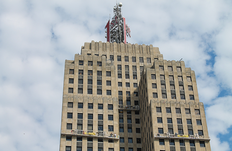 First National Bank Building in St. Paul showing detailed stone facade work during restoration process