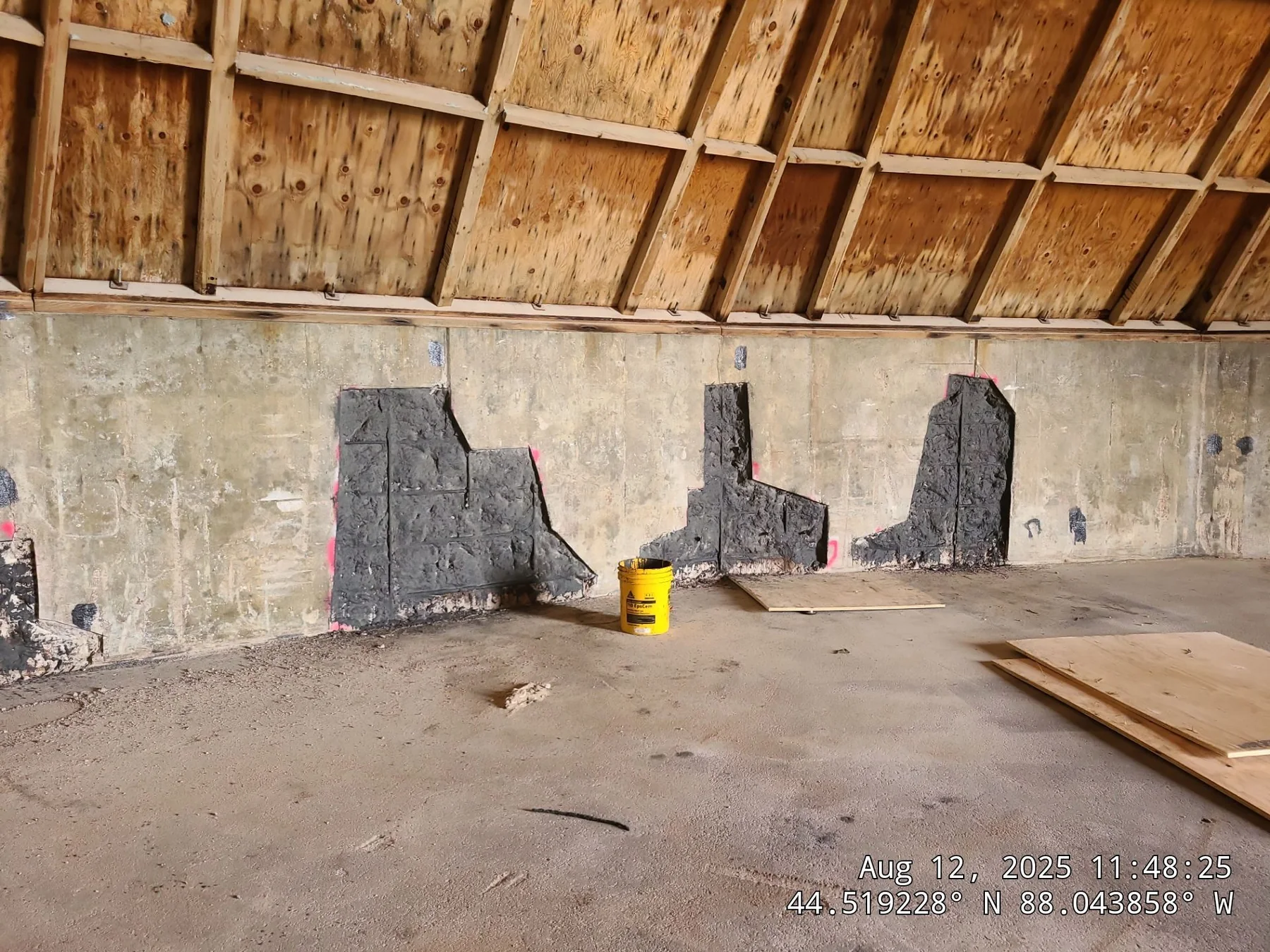 Industrial concrete wall with protective coating test patches inside a commercial structure