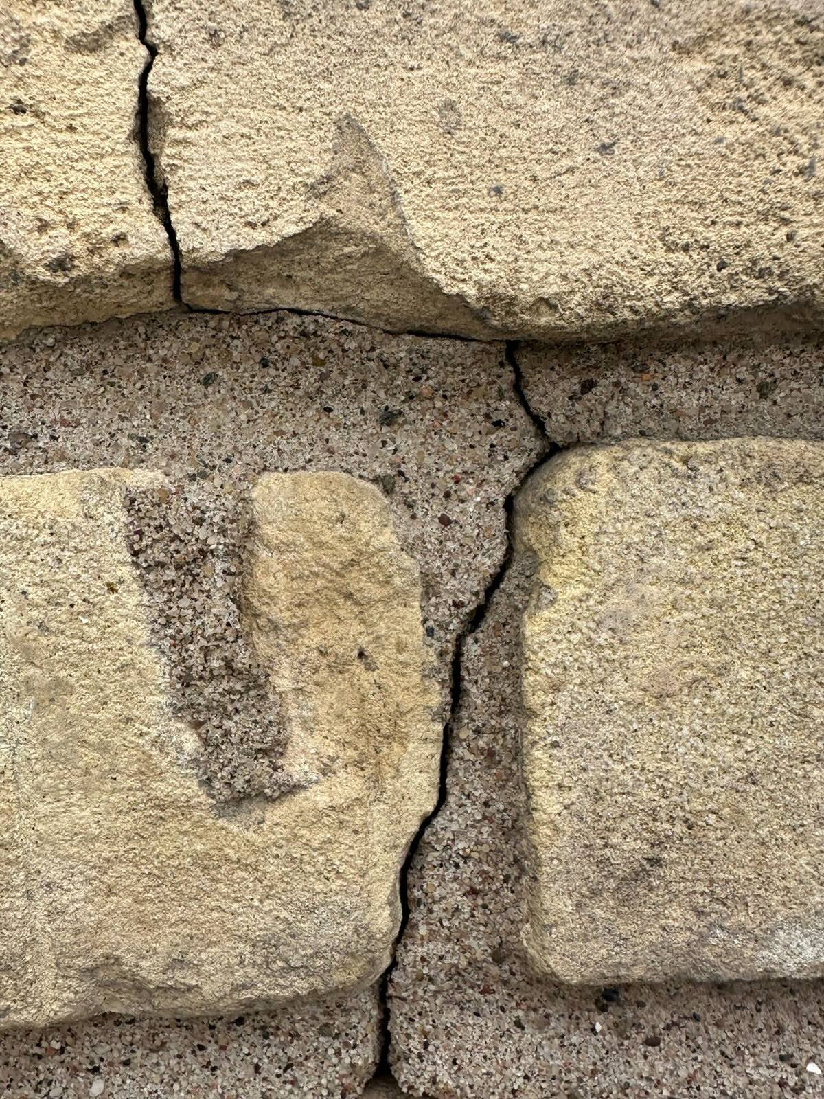 Close-up of deteriorating mortar joints between bricks