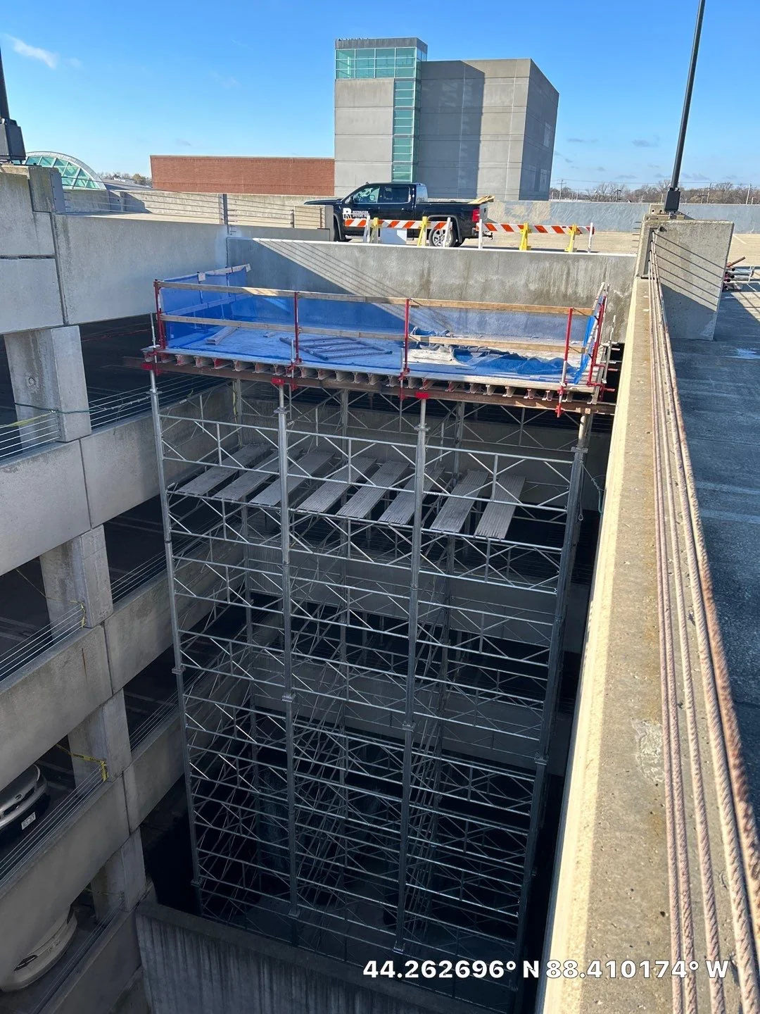 Multi-level structural shoring tower installed in a parking structure repair zone